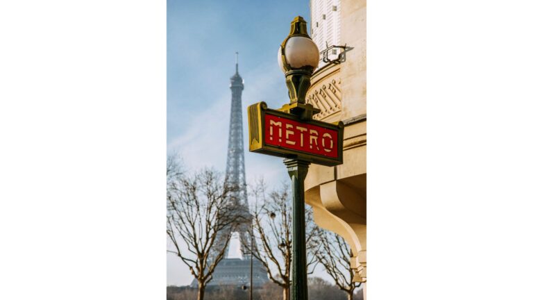 the paris metro framed by eiffel tower