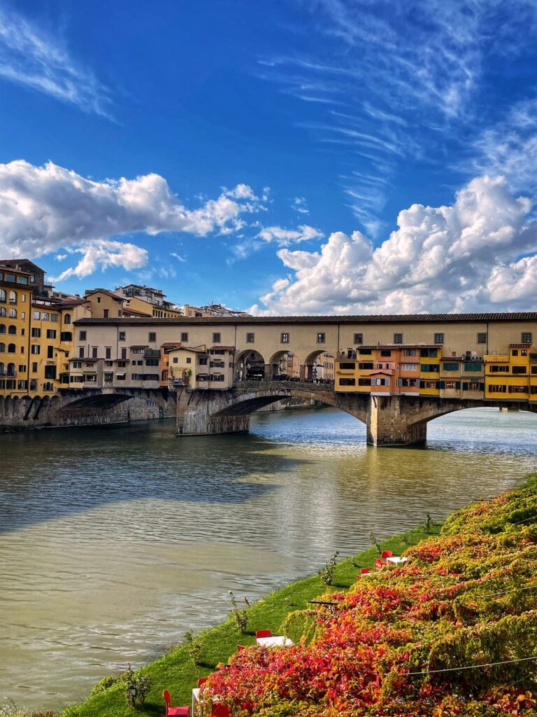 spring flowers wreathe the ponte vecchio in florence